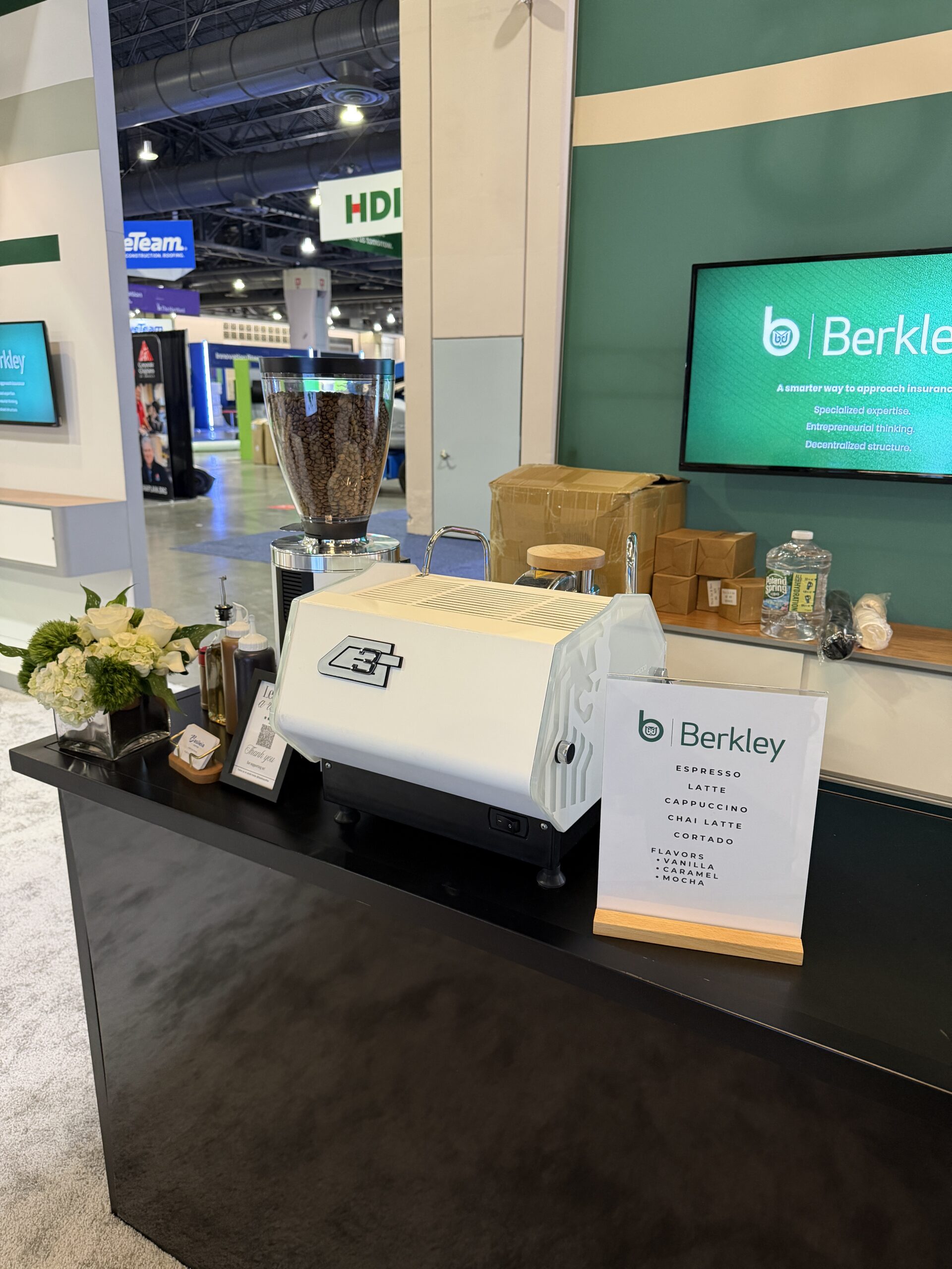 Custom branded coffee cart setup at RIMS RiskWorld 2026 Philadelphia expo floor