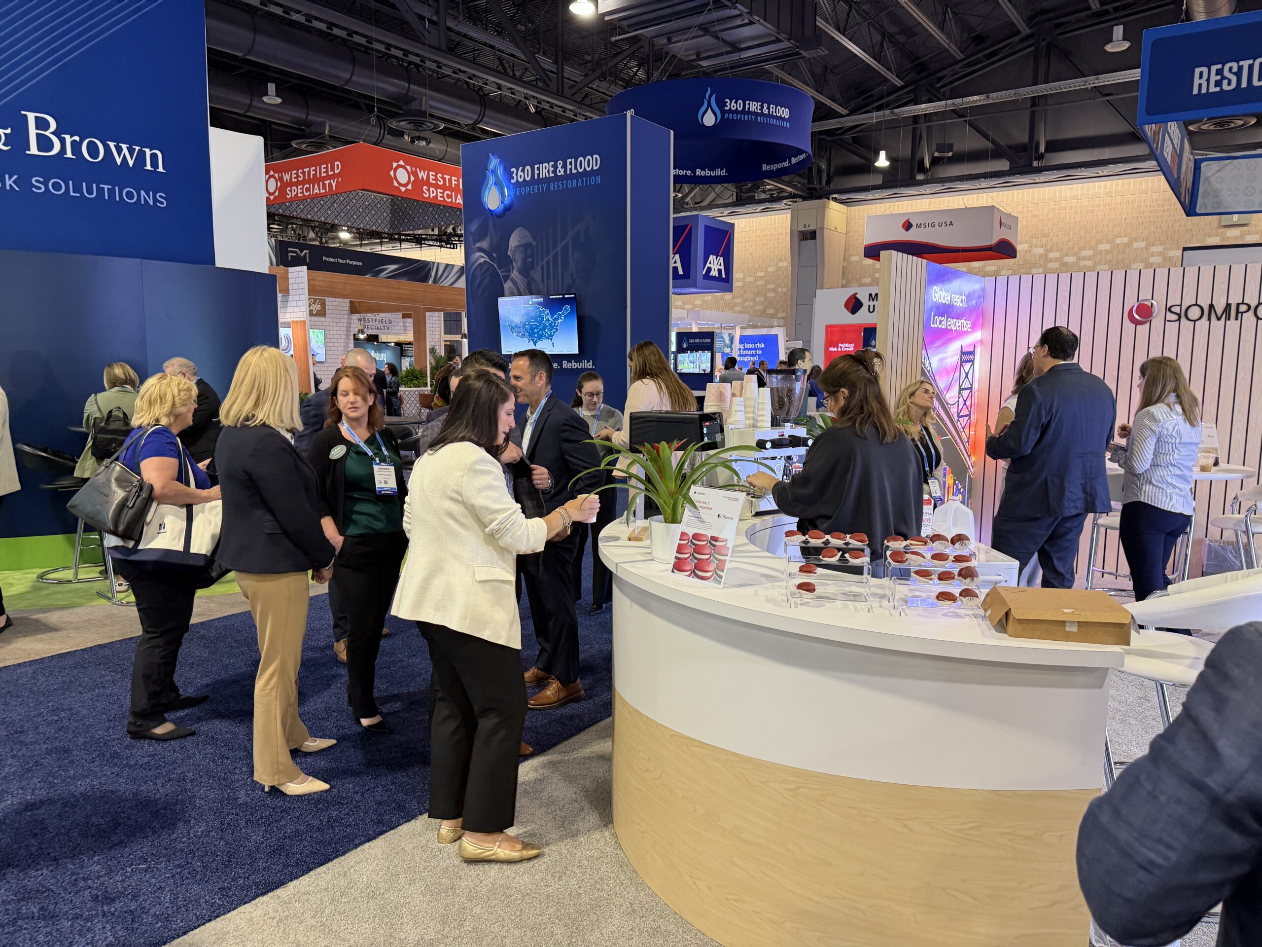 Busy convention floor with coffee bar drawing attendees at RIMS RiskWorld 2026 Philadelphia