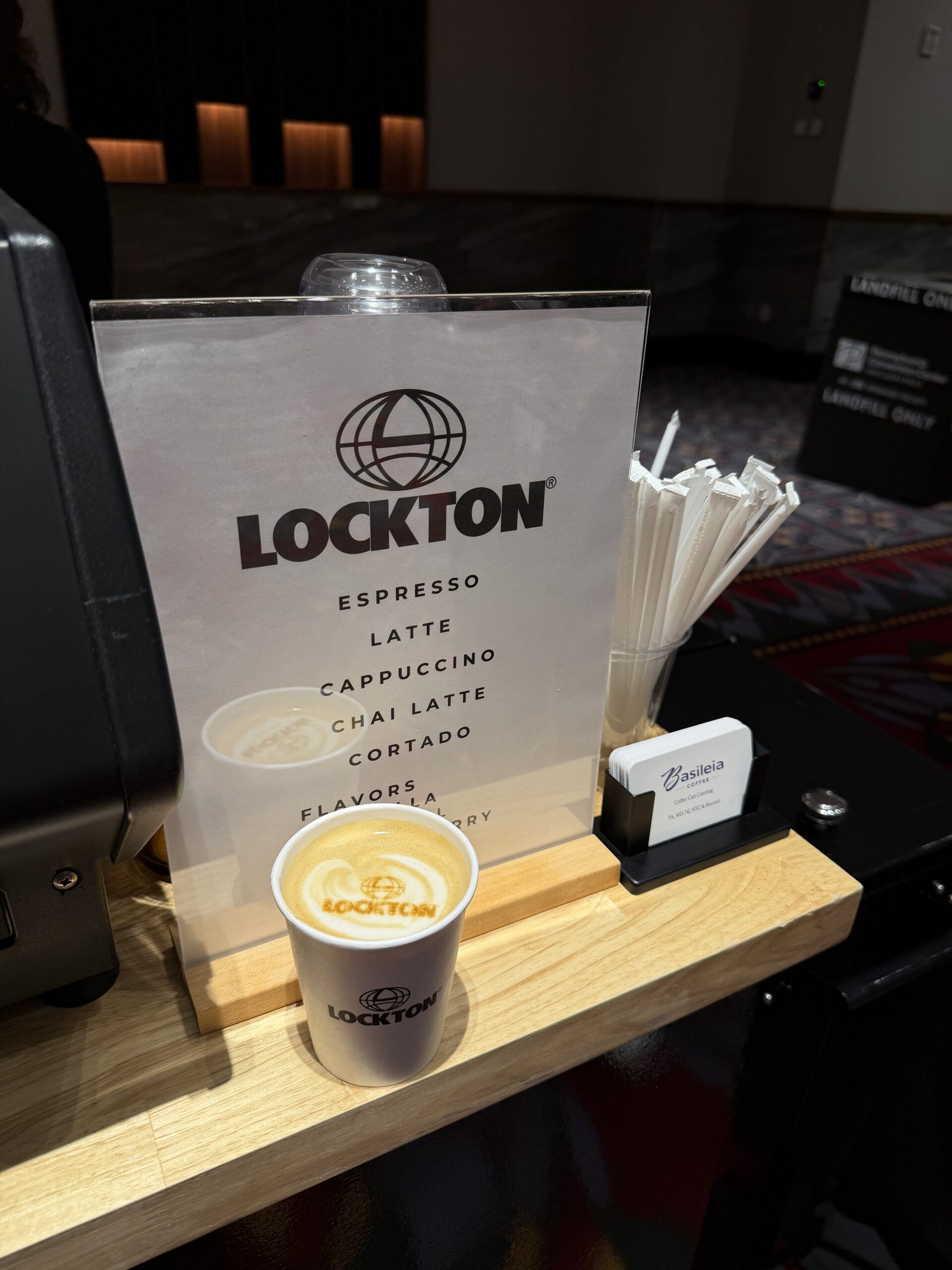 Branded coffee cup with custom latte art logo printed at RIMS RiskWorld 2026