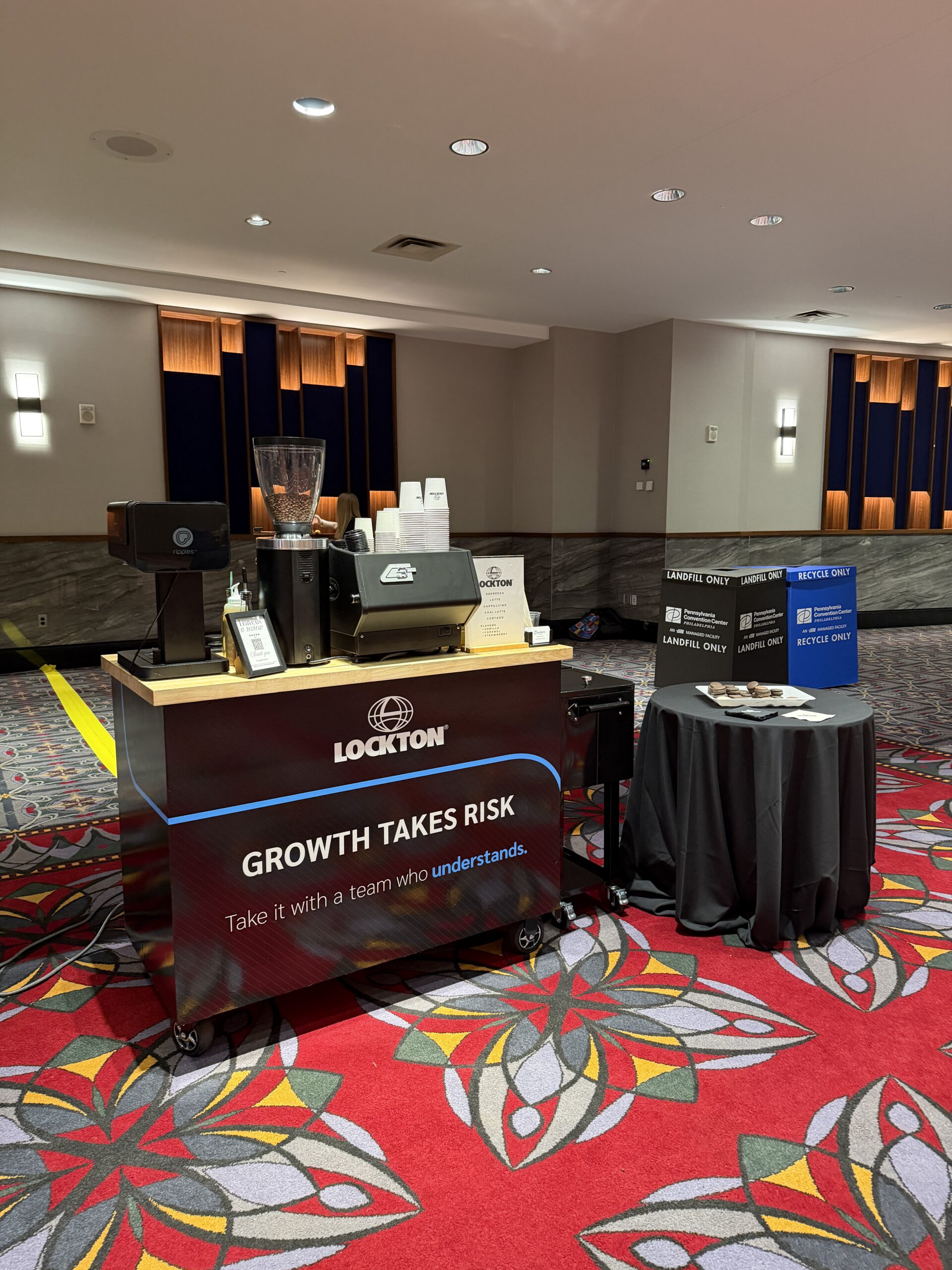 Custom branded Basileia coffee cart at RIMS RiskWorld 2026 Pennsylvania Convention Center Philadelphia