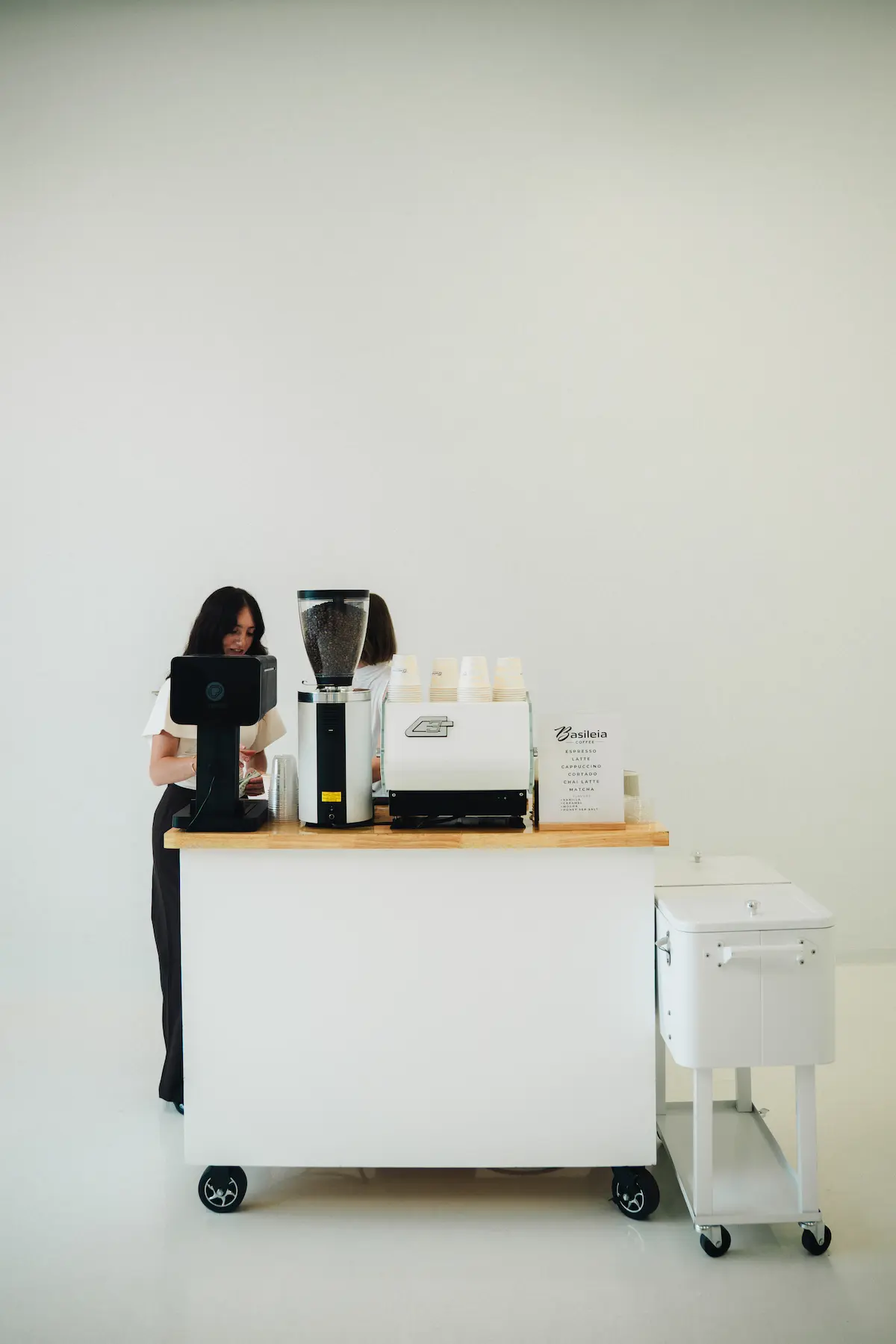 Basileia barista at a mobile coffee cart with a full espresso setup