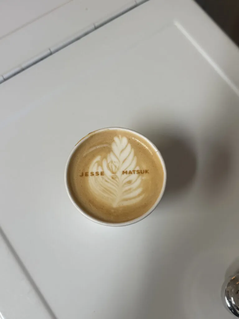 Latte with custom latte art served at an event